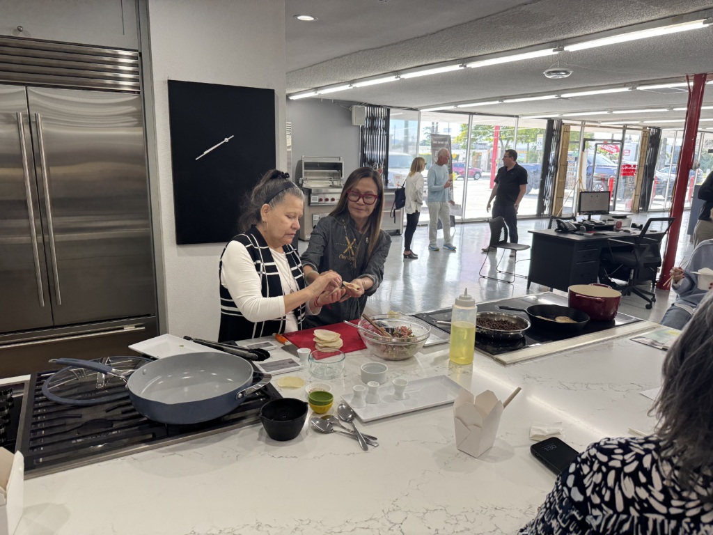 Photo Caption: Chef Katie Chin demonstrates to a customer how to make potstickers on an induction stovetop at Waadt Appliance in Lake Balboa, CA. 